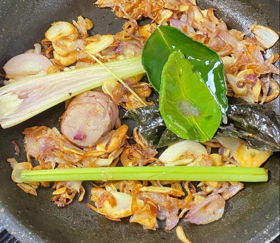 Step 1.1: Fry the rice aromatics (shallots, garlic, lemongrass, galangal, lime leaves, bay leaf) until fragrant and golden brown