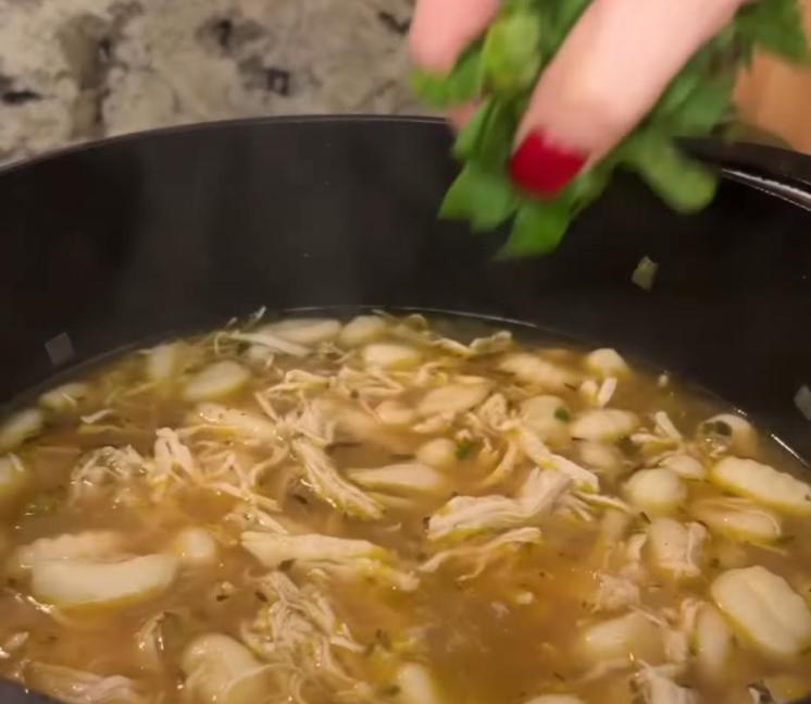 Step 3.1: Return shredded chicken to the pot along with chopped spinach and heavy cream, stirring to combine and heating through