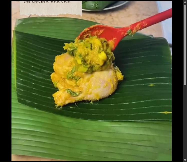 Step 4.1: On a banana leaf, place a bay leaf, lemongrass, the chicken, and chili