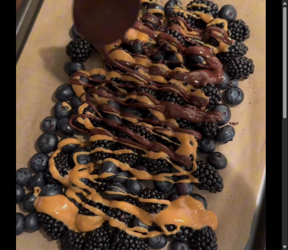 Step 1.1: Drizzle melted chocolate and creamy peanut butter over the berries