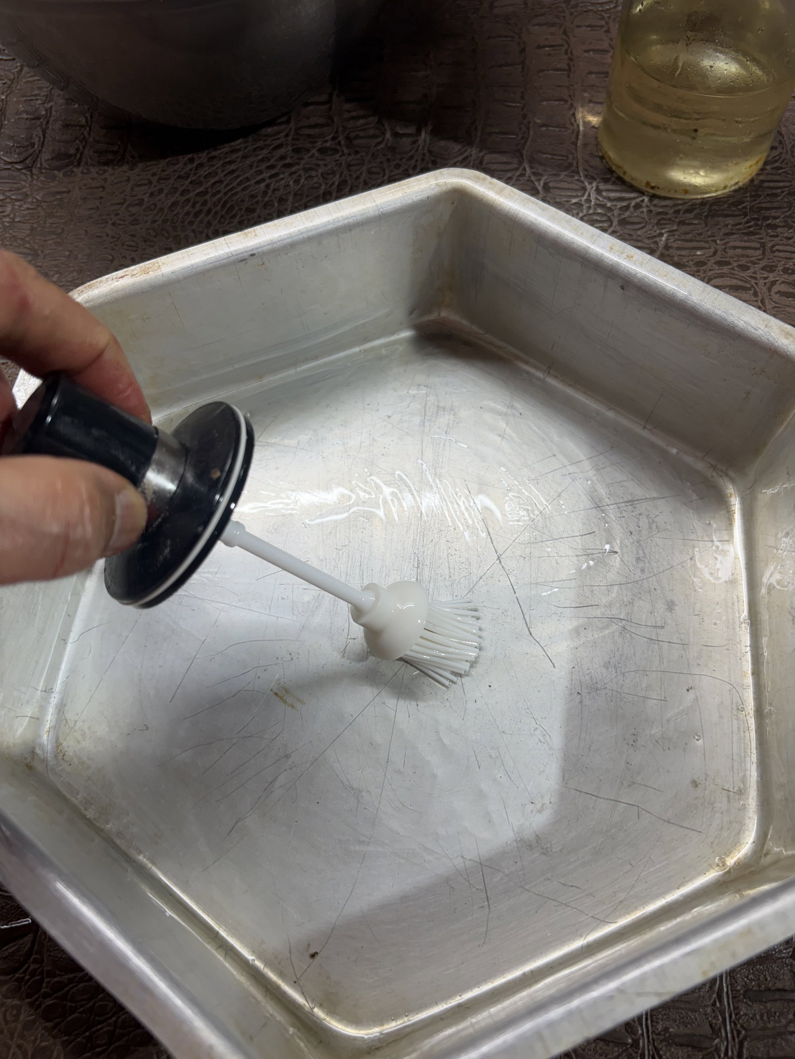 Step 2.1: Lightly grease a 7-inch cake tin, steel container, or dhokla plate with oil and set it aside