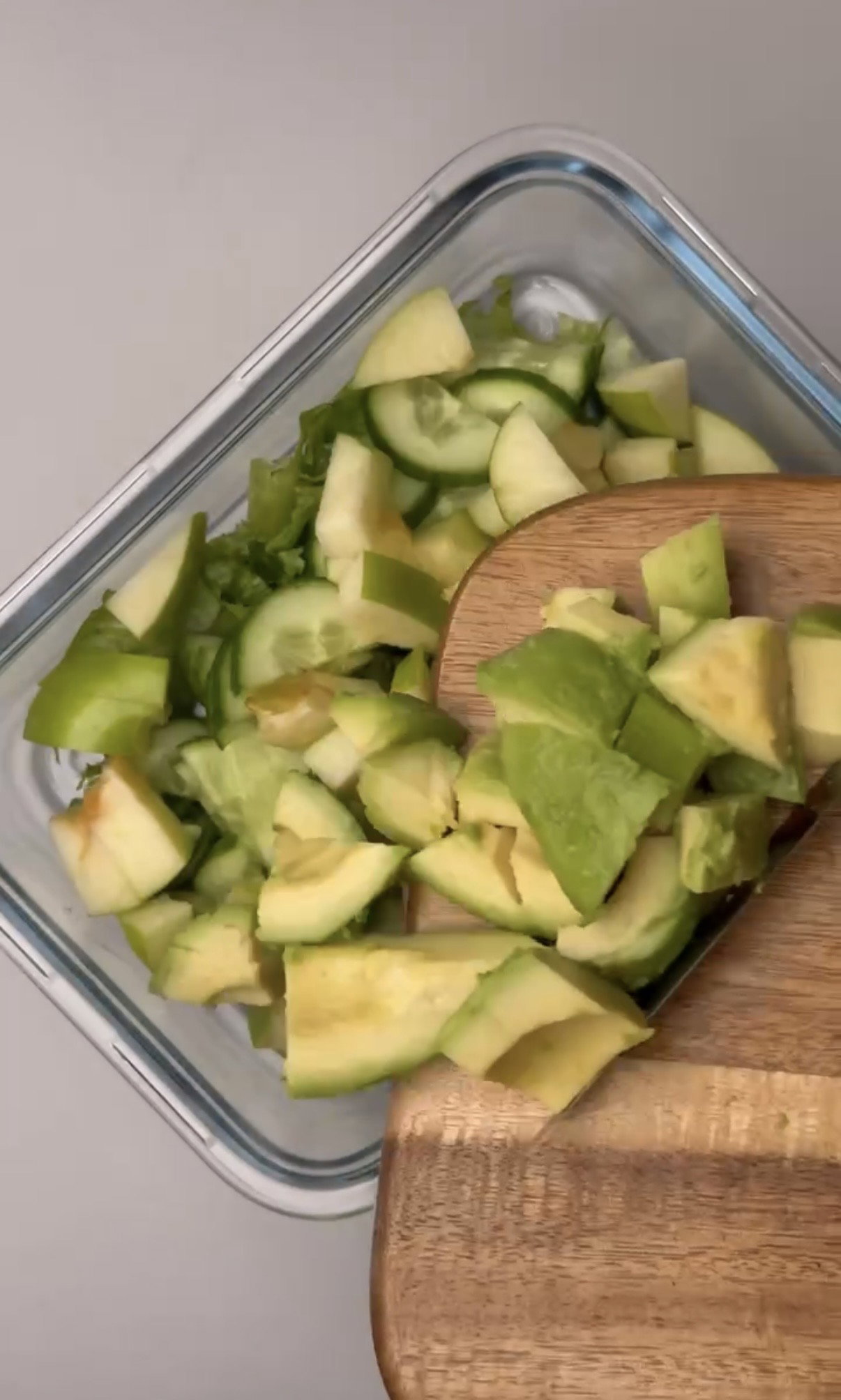 Step 1.1: Add lettuce, cucumber, green apple, avocado, cooked chicken breast, walnuts, and red onion to a container