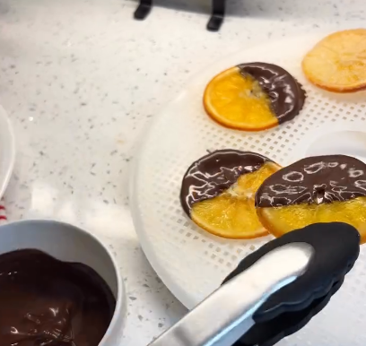 Step 1.1: Dip half of each slice into melted dark chocolate and let them set on parchment