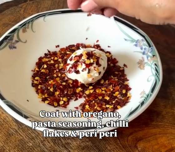 Step 2.1: Coat the labneh balls evenly with oregano, pasta seasoning, chilli flakes, and peri peri masala