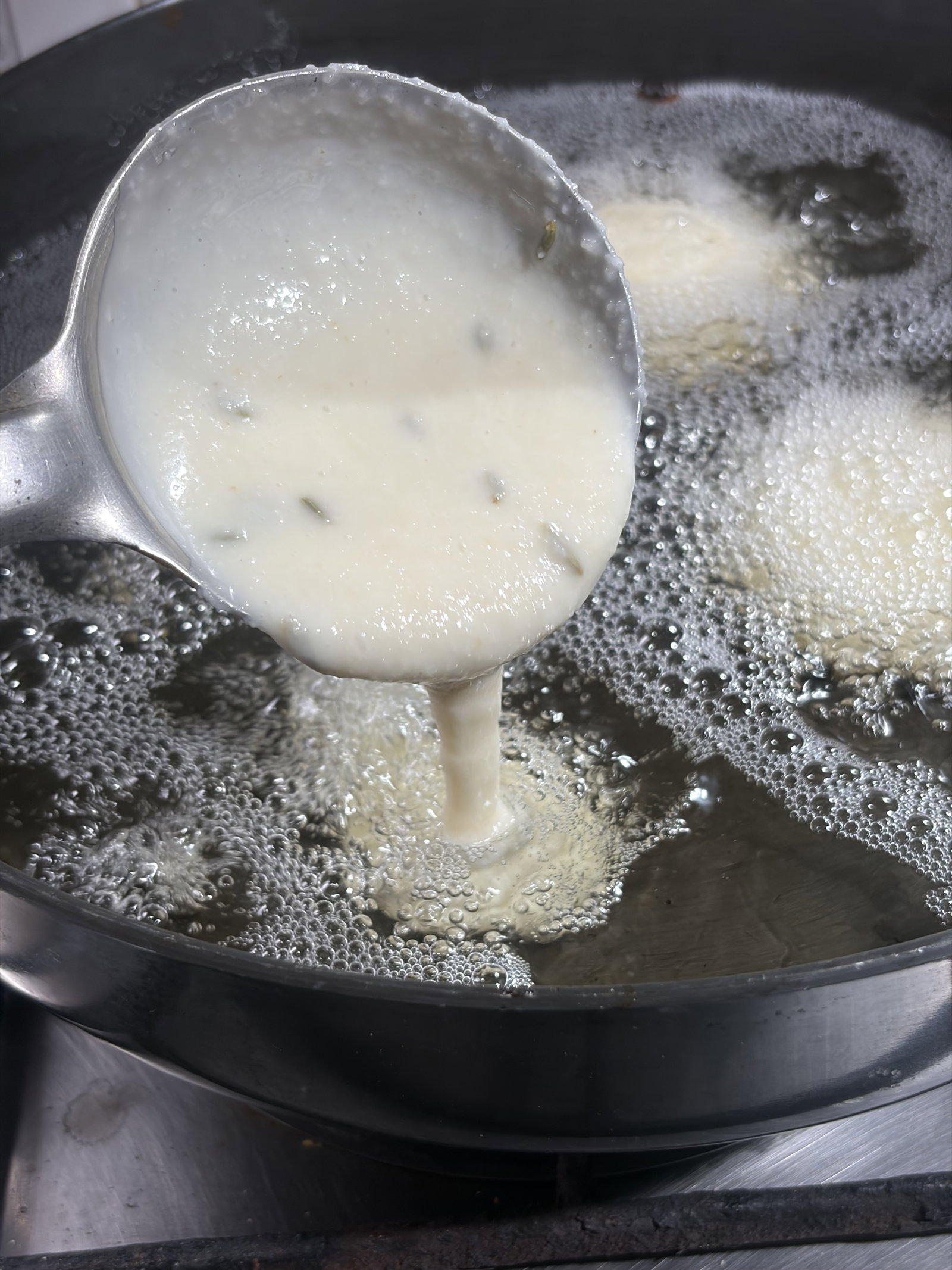 Step 2.1: Using a round ladle, pour a small amount of batter into the centre