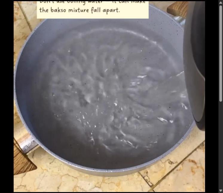 Step 1.1: Heat 1 liter of hot water in a pot, ensuring it is not boiling to prevent the bakso mixture from falling apart