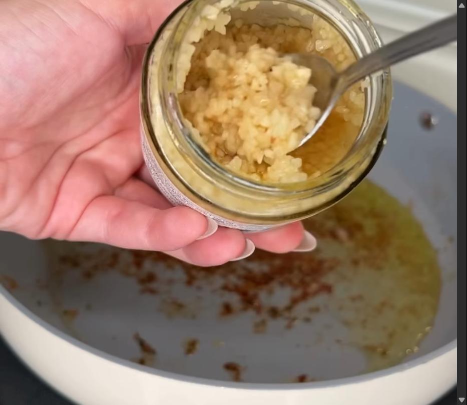 Step 2.1: Add garlic and pearl couscous to the pan and cook for 1 minute, scraping the brown bits from the bottom of the pan