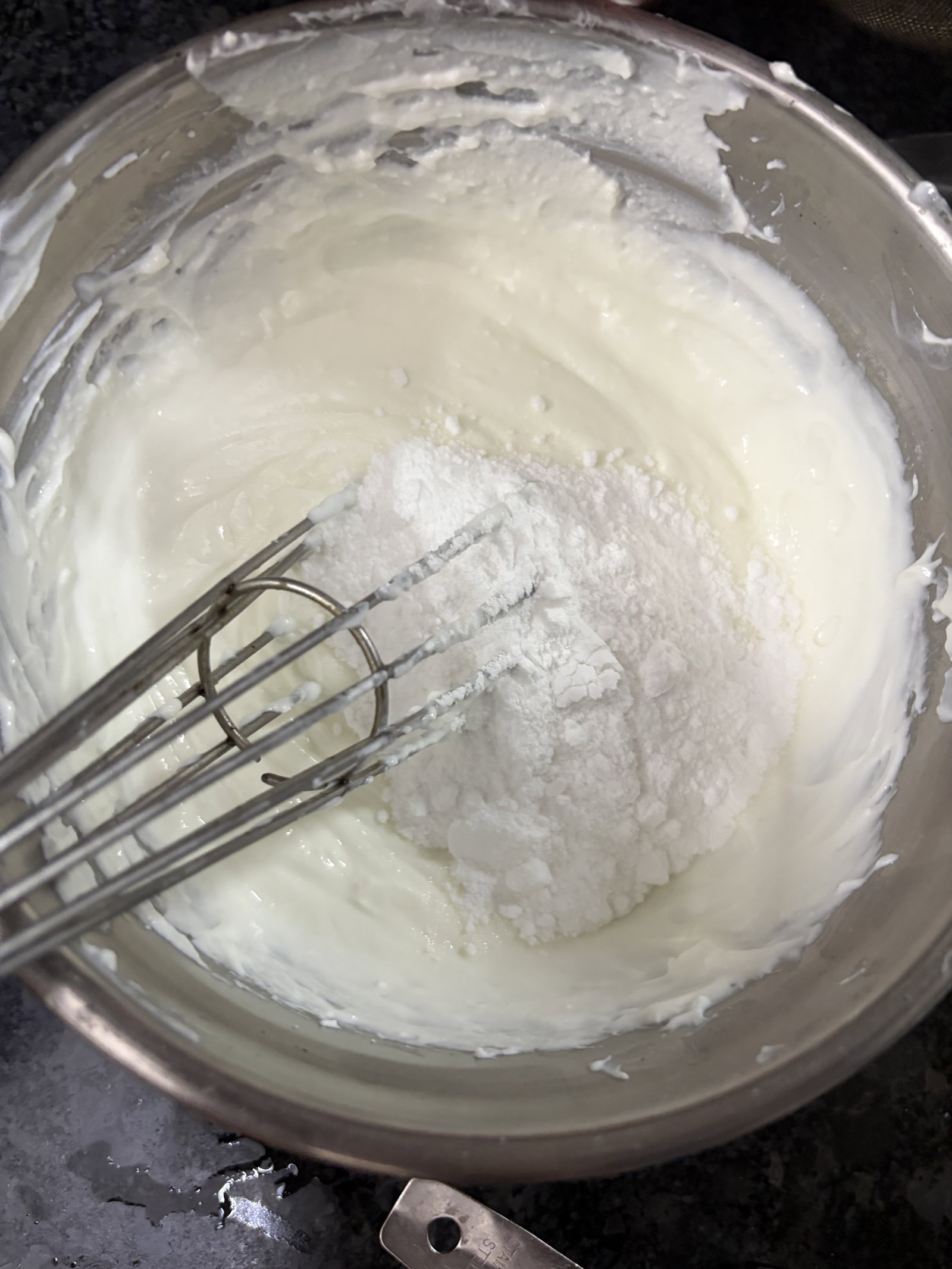 Step 2.1: Add the powdered sugar to the whipped curd