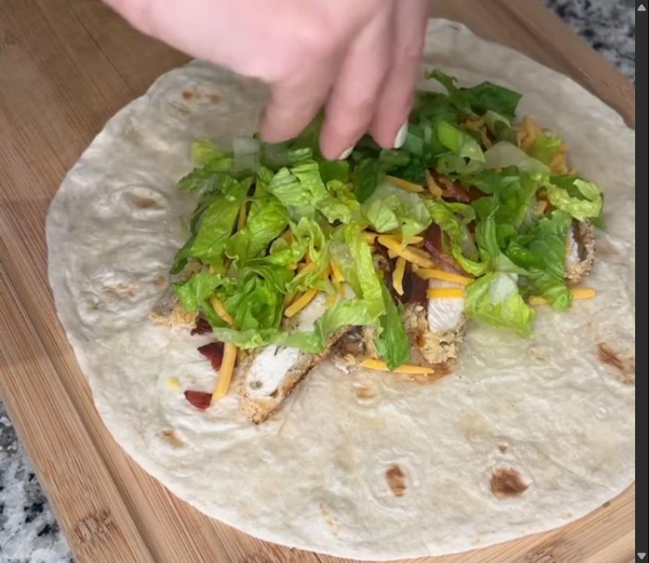 Step 3.1: Place chicken, bacon, shredded cheese, lettuce, green onions, and ranch dressing on a large tortilla