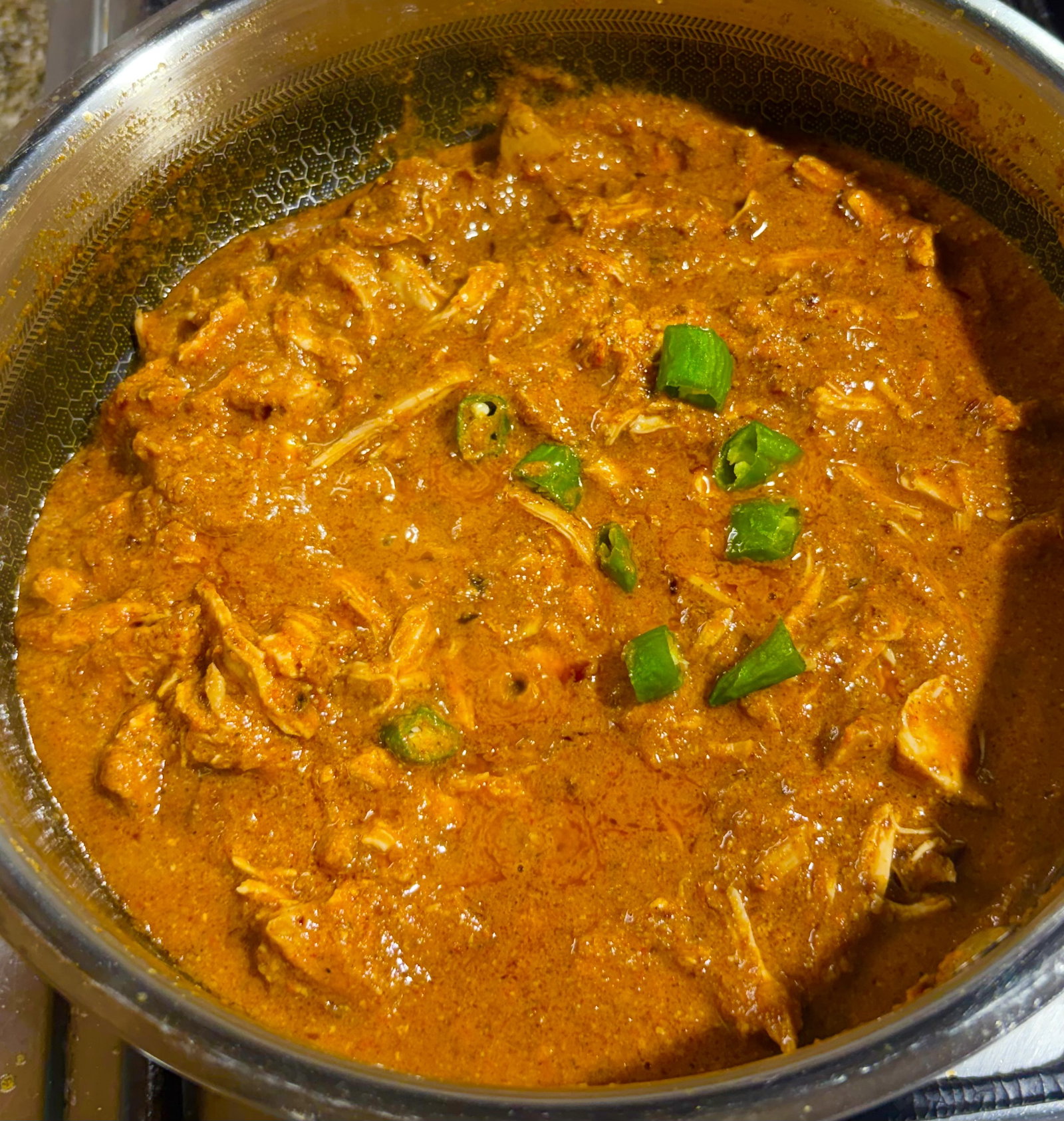 Step 4.1: Add the slit green chilli (moti mirch) and let the curry simmer on low for 3–5 minutes so the chicken absorbs the flavours
