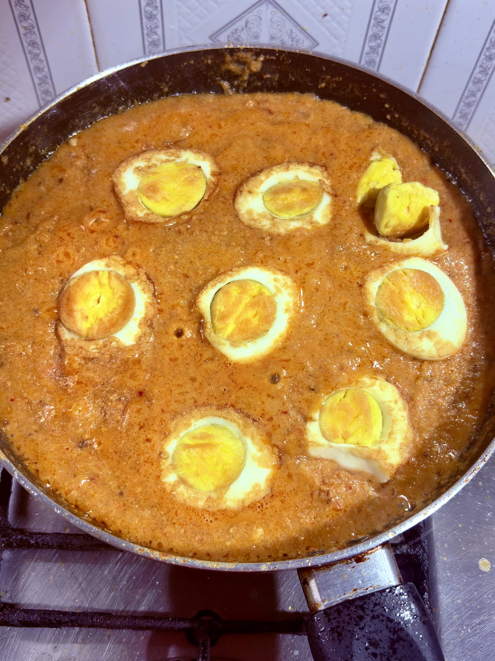 Step 5.1: Gently place the seared eggs and 4-6 cashews into the gravy