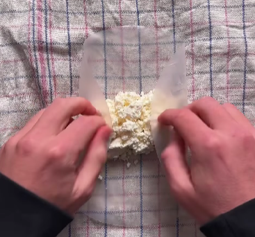 Step 1.1: Add crumbled feta into the center of the rice paper, fold in the sides, and roll tightly