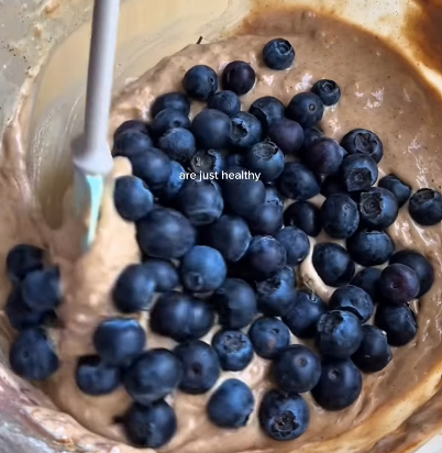 Step 1.1: Fold in the fresh blueberries, leaving some aside for topping