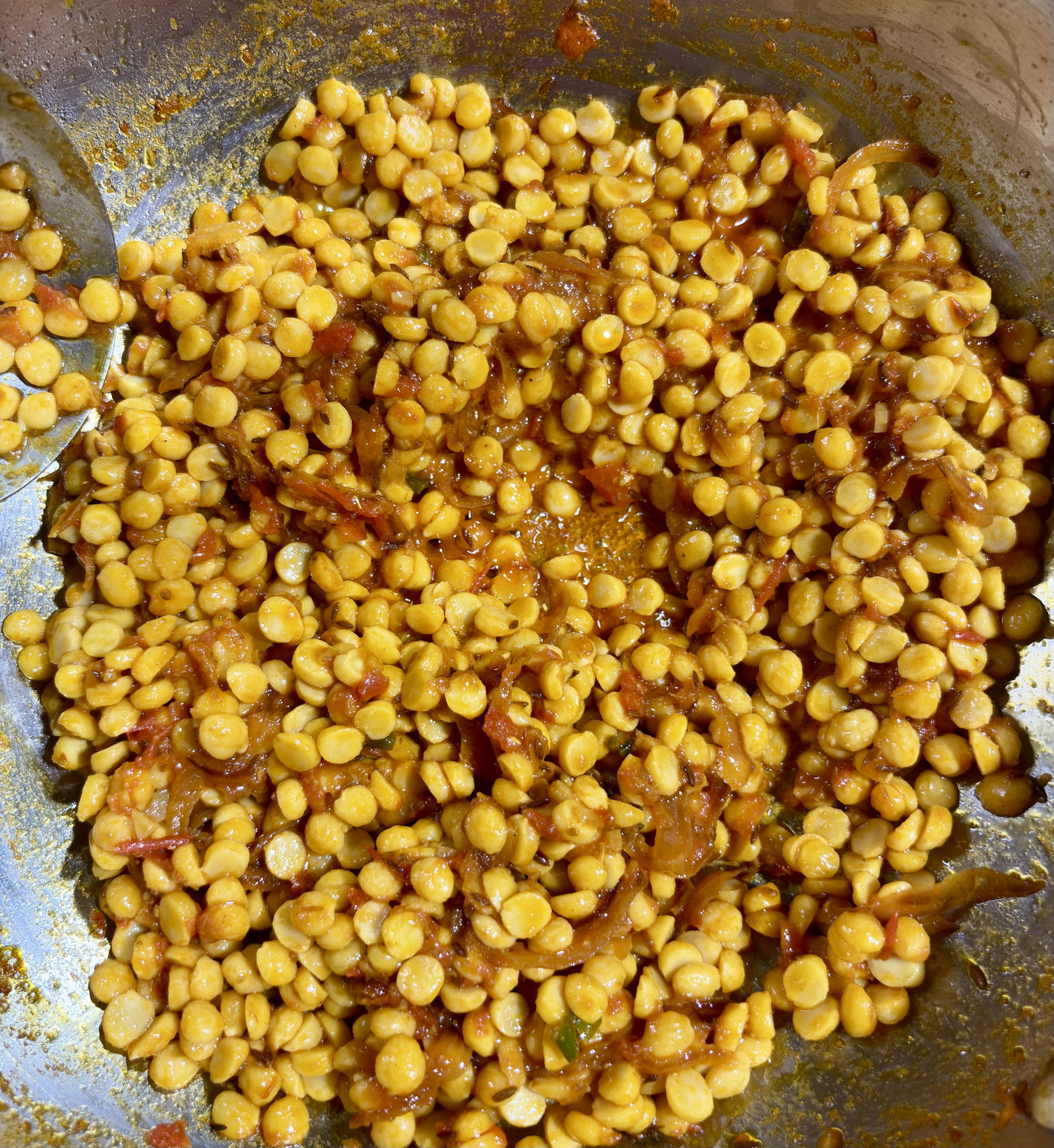 Step 4.2: Add the soaked chana dal and stir-fry for 3-4 minutes, ensuring every grain is coated with the masala