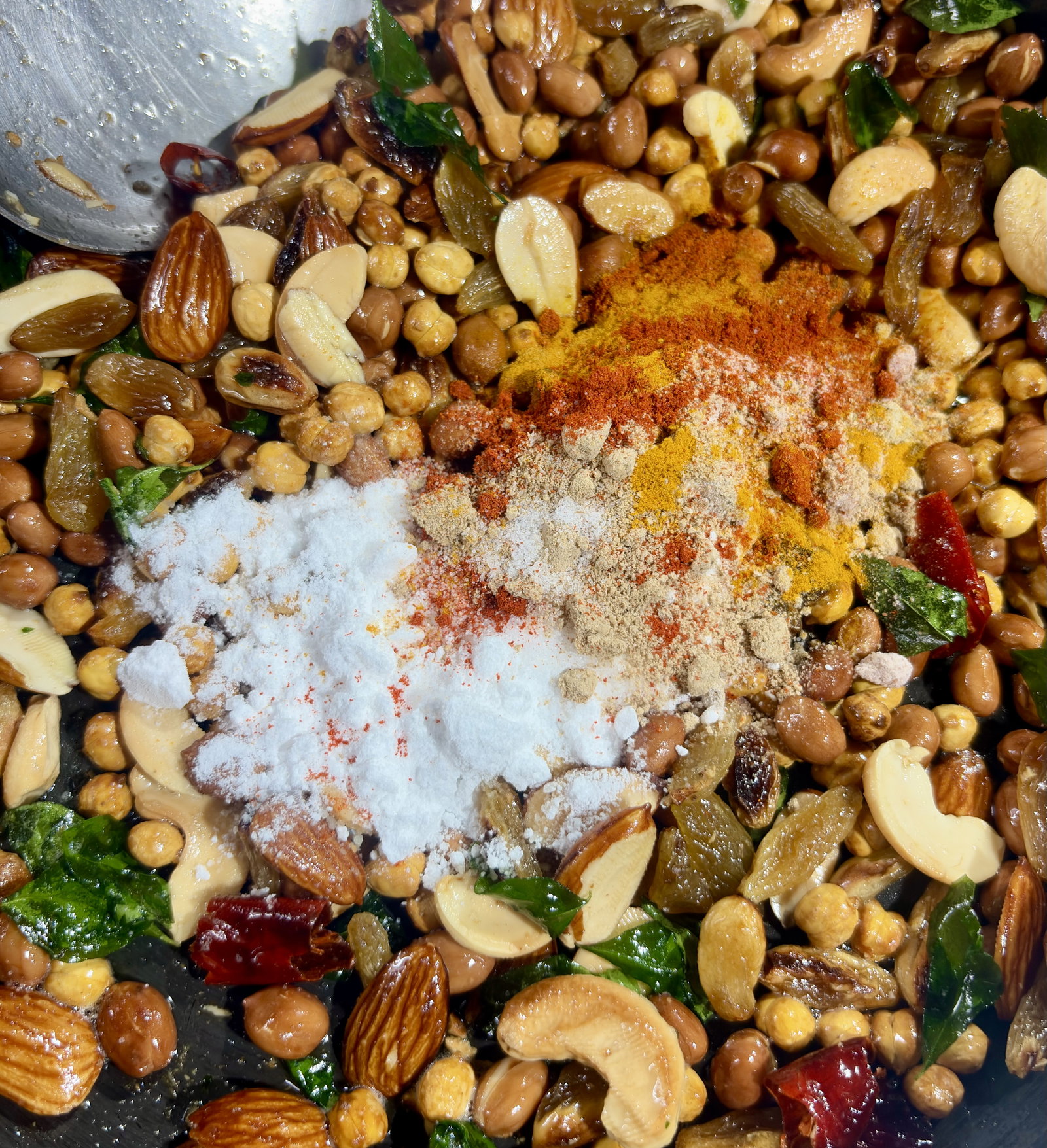 Step 3.1: Add turmeric powder, red chilli powder, amchur powder, chaat masala, black salt, salt, and powdered sugar to the oil
