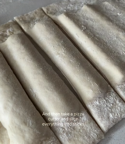 Step 1.1: Use a pizza cutter to slice the dough-wrapped mozzarella into sticks