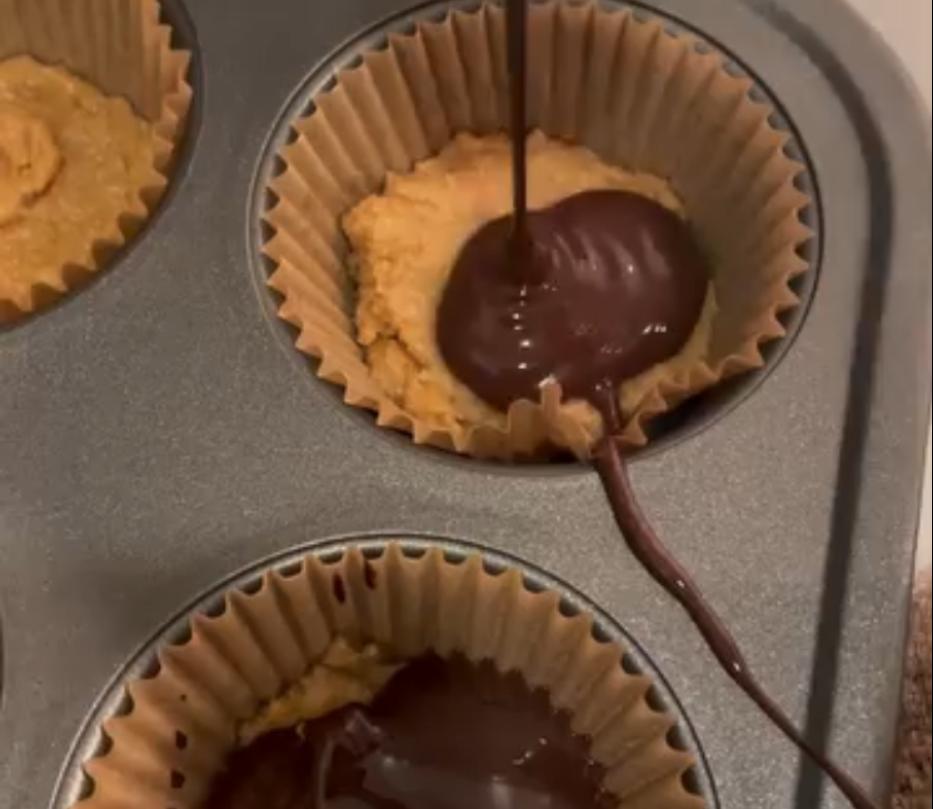 Step 2.1: Pour the melted chocolate and peanut butter mixture over the 1st layer in the muffin tin