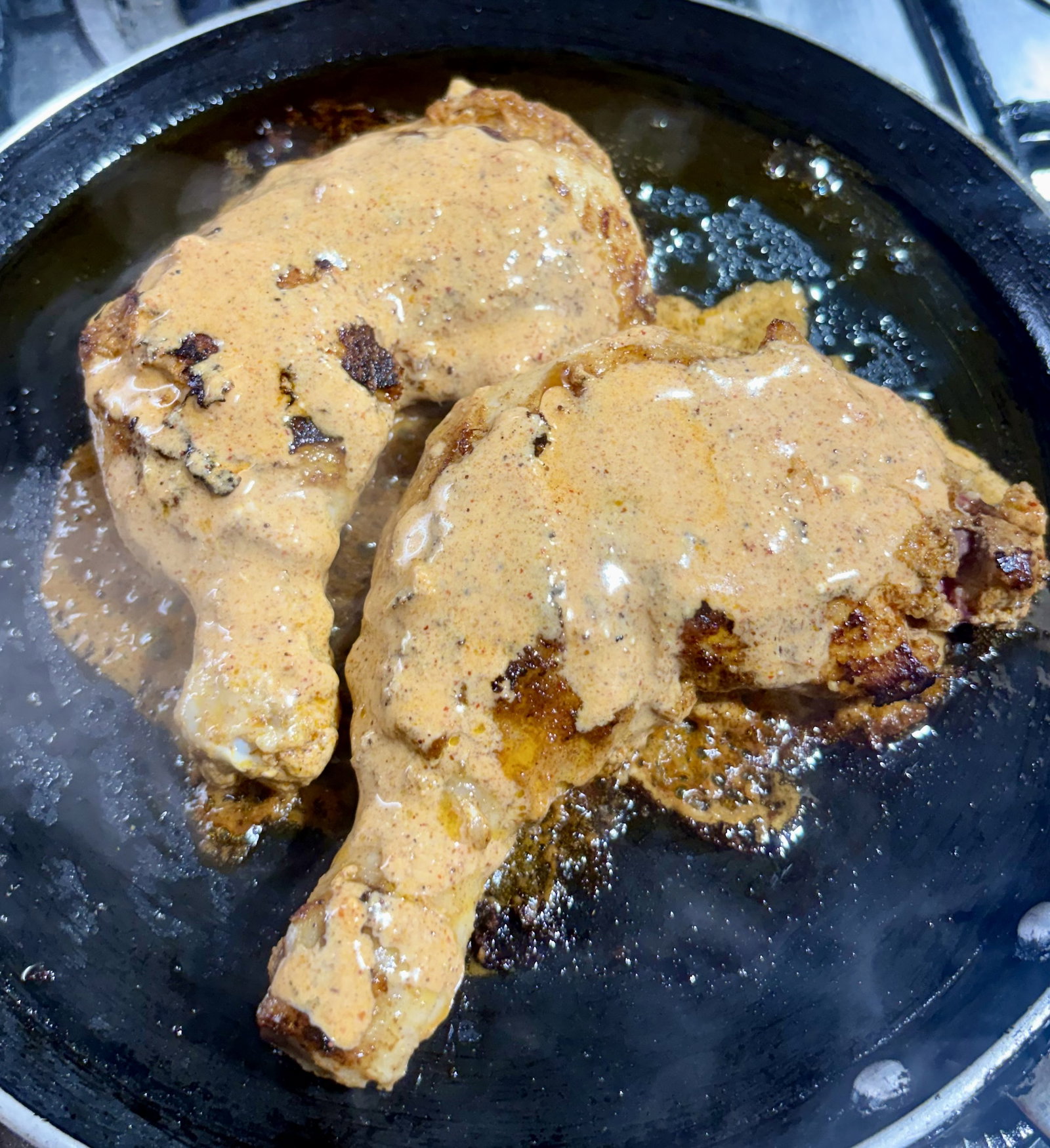 Step 3.1: Reduce the heat to medium-low and pour the reserved marinade over the chicken pieces