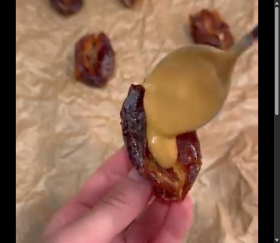 Step 1.1: Spread peanut butter inside each pitted date, then top with crushed roasted peanuts