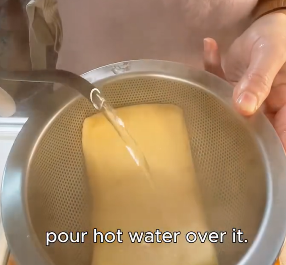 Step 1.1: Pour hot water over the aburaage to remove excess oil and set aside