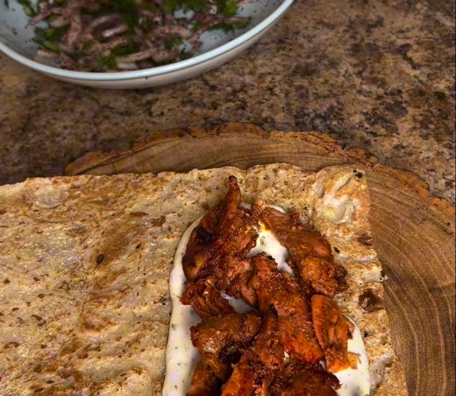 Step 4.1: Wrap the tandoori shawarma in tanoor bread or naan with the yogurt sauce and onions, and enjoy