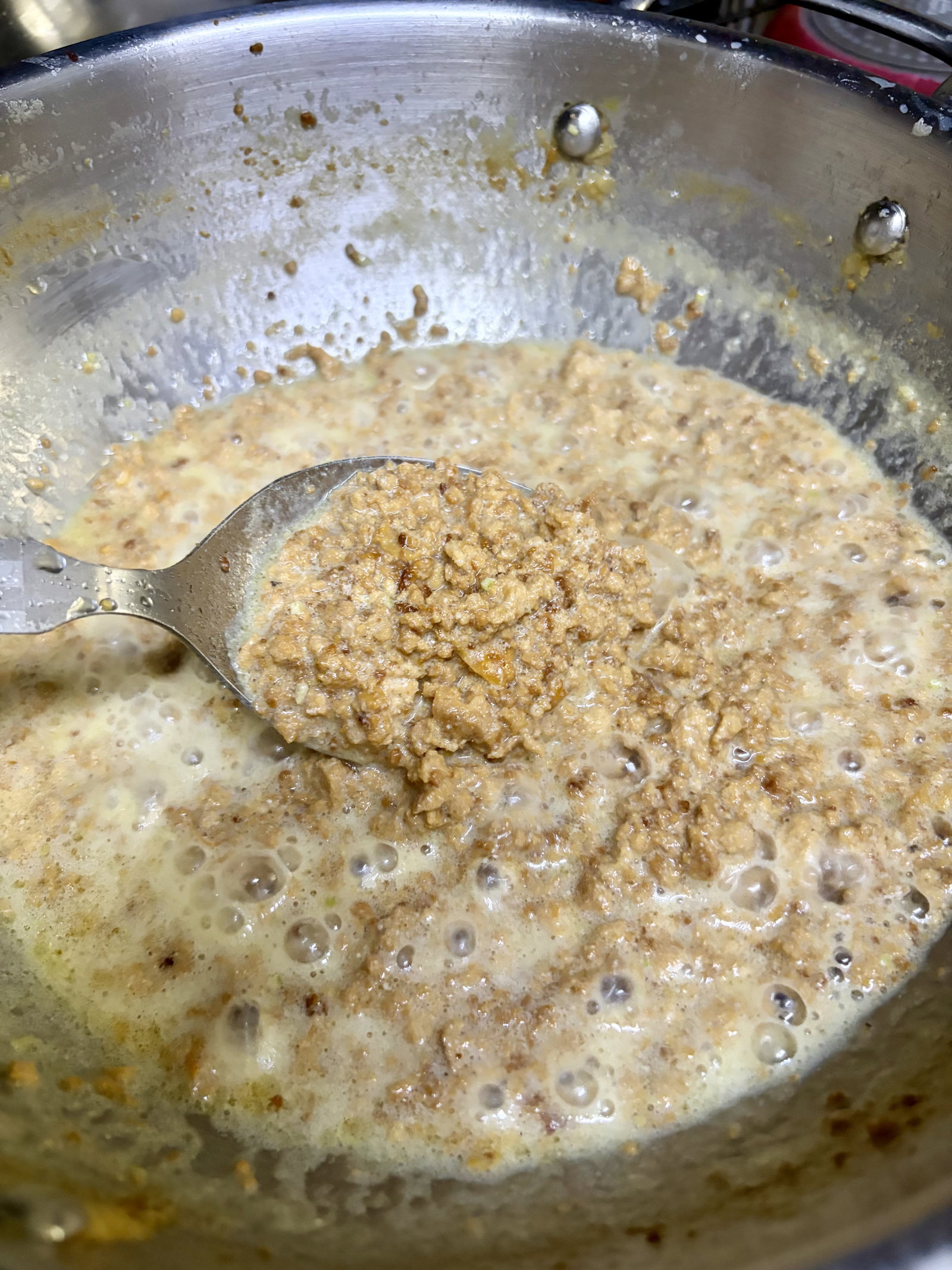 Step 3.2: Stir the milk solids (ghee residue) directly into the boiling milk and mix well for 3-4 minutes