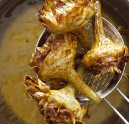 Step 2.1: Raise the oil temperature to 180°C (355°F) and fry the artichokes again until golden and crisp