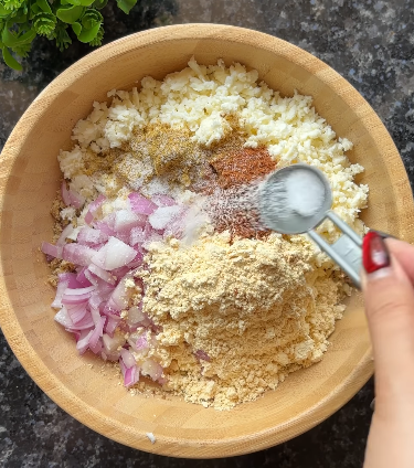 Step 1.2: Smash the kala chana and mix it with shredded low-fat paneer, chopped onion, besan, cumin powder, coriander powder, garam masala powder, salt, and chopped coriander