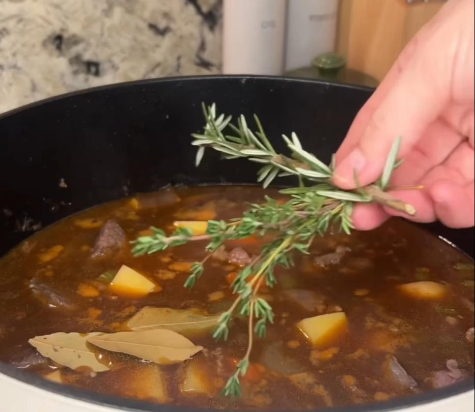Step 2.1: Add beef broth, Worcestershire sauce, potatoes, beef chunks, and fresh herbs to the pan