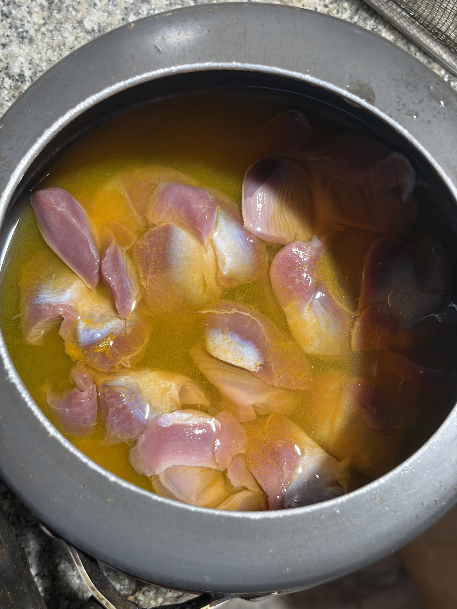 Step 1.1: Place the gizzards in a pot or pressure cooker with turmeric powder, salt, and water