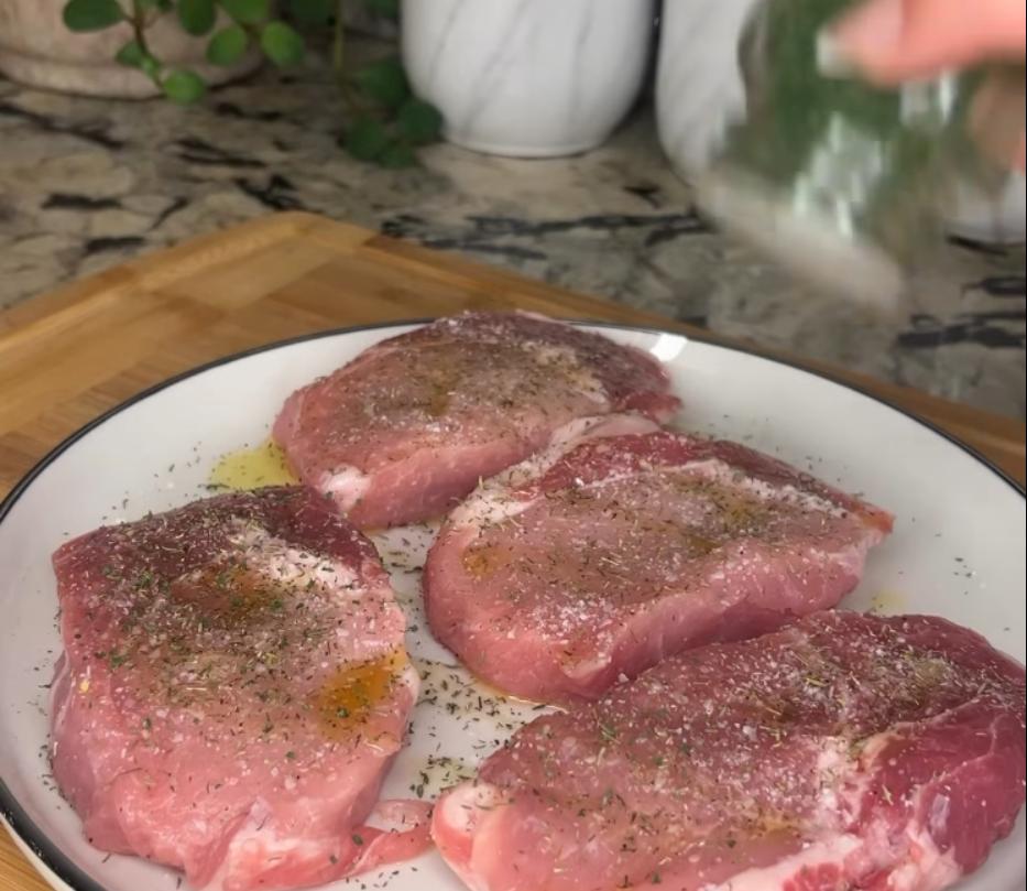 Step 1.1: Drizzle olive oil on pork chops and season both sides with salt, pepper, thyme, and parsley