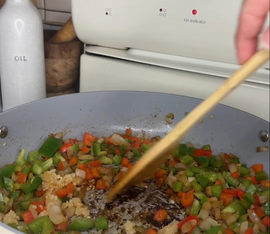 Step 1.1: Add diced onion, green bell pepper, red bell pepper, and minced garlic to the pan
