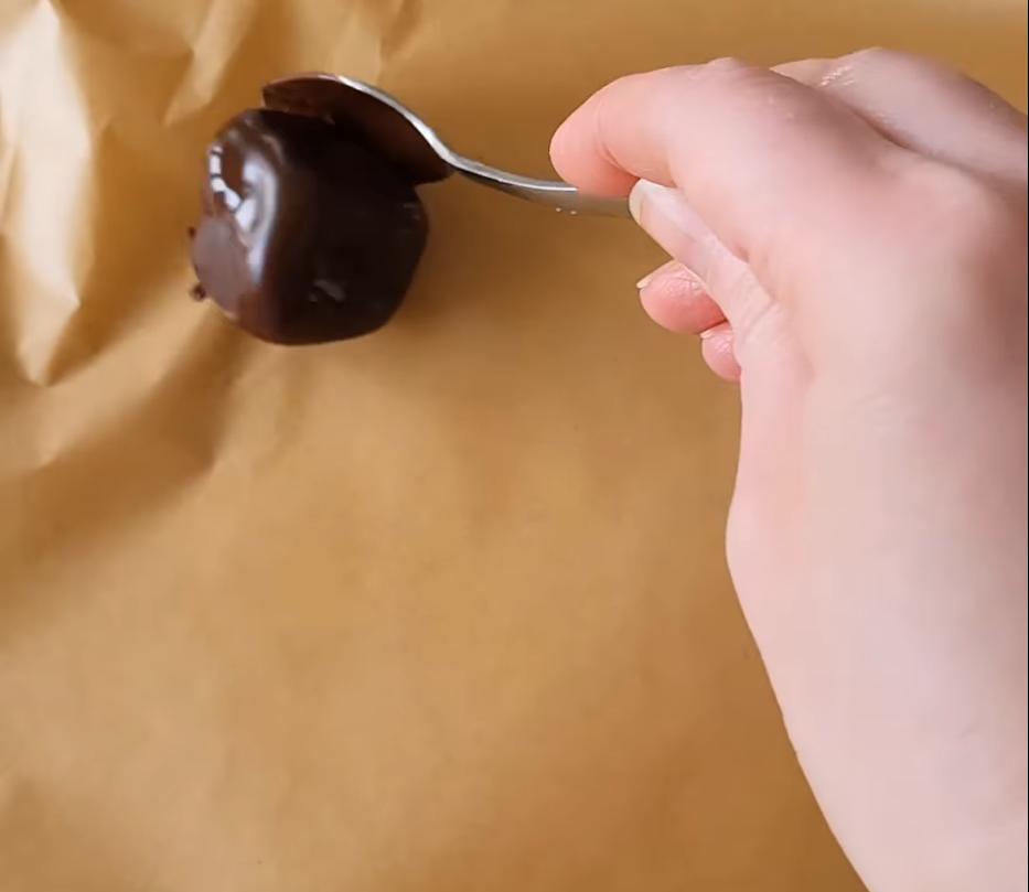 Step 1.1: Place the coated mango pieces on a lined baking tray and freeze until the chocolate is set