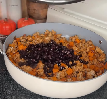 Step 1.1: Add sweet potato, red onion, garlic, chili powder, cumin, coriander, paprika, and black beans to the pan