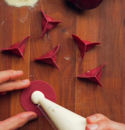 Step 5.1: Pipe the filling evenly, then fold and seal into an origami-style ravioli shape