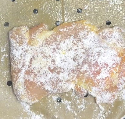 Step 1.1: Lightly coat the chicken in olive oil, then press it into the potato starch mixture, ensuring an even coating