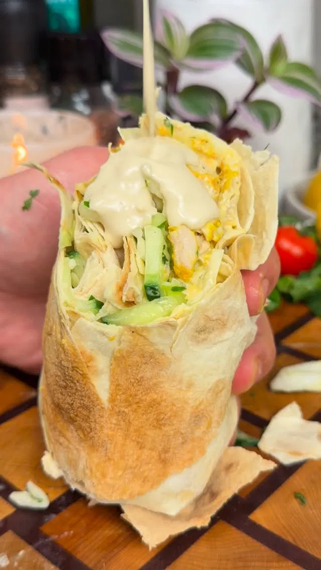 Step 4.1: Drizzle more tahini sauce over the top, then roll tightly, folding in the edges as you go