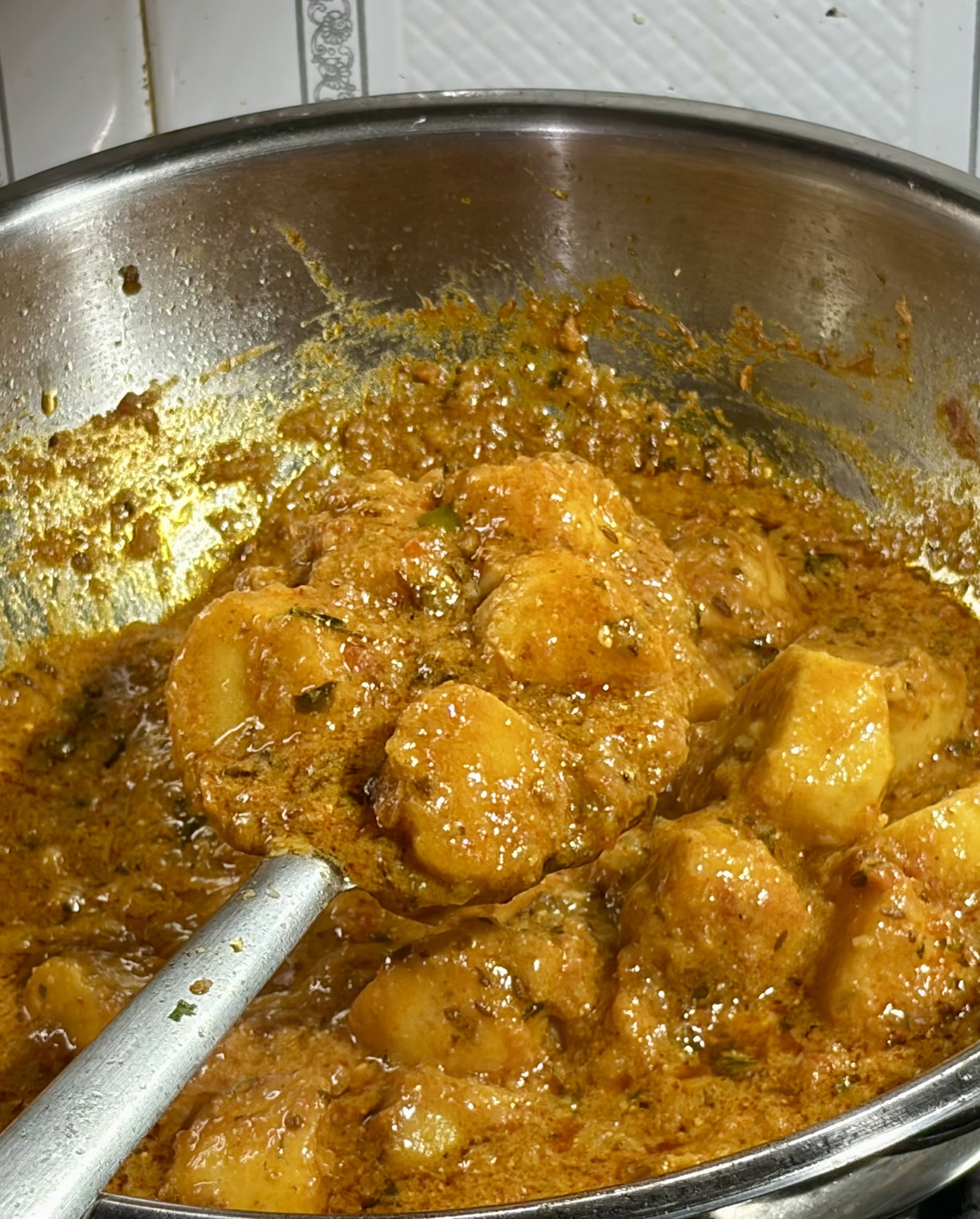 Step 5.1: Cover and simmer for 10–12 minutes until the arbi is tender and has fully absorbed the flavours