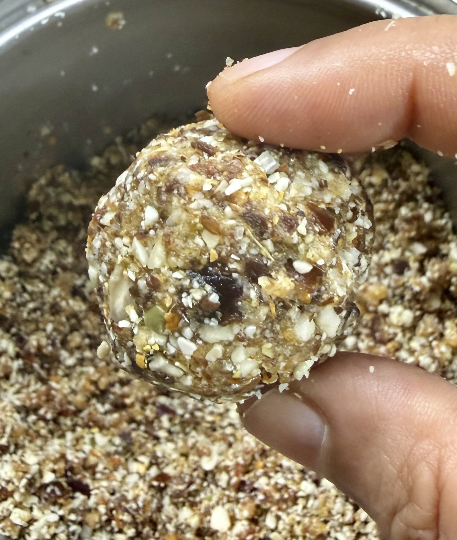 Step 3.1: Take small portions of the date mixture and roll them between your palms into tight, smooth, lemon-sized balls