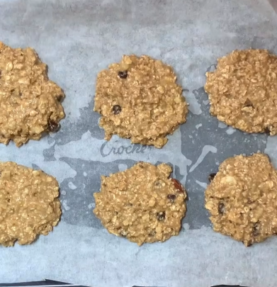 Step 3.1: Scoop the mixture onto a baking tray lined with parchment paper, forming approximately 12 cookies