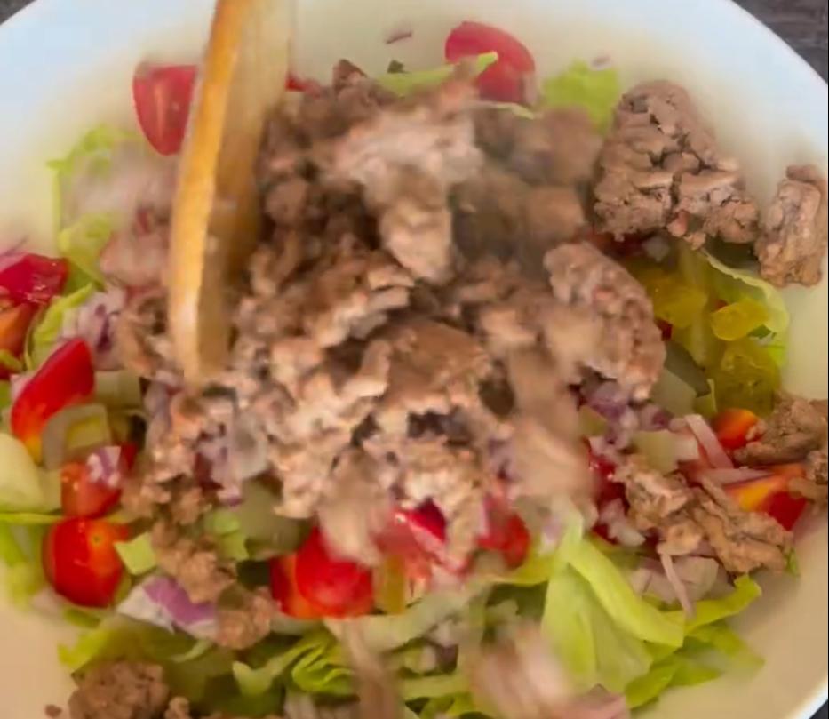 Step 1.1: Assemble the bowl with shredded lettuce, cherry tomatoes, red onion, and pickles, then add cooked beef mince and shredded mozzarella