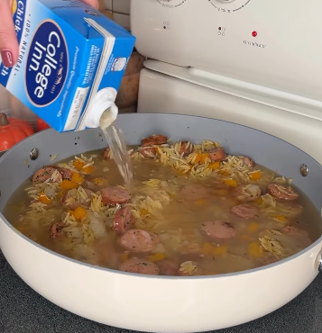 Step 1.1: Pour in chicken broth and heavy whipping cream, and bring to a boil