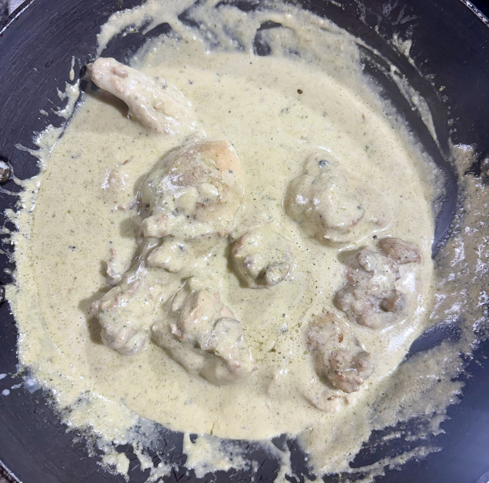 Step 4.2: Lower the heat, then add the cashew-cream paste and the cornflour slurry, stirring continuously for a few seconds