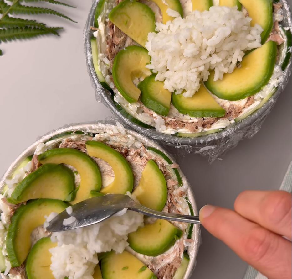 Step 1.2: Layer cucumber, seasoned rice, cream cheese, tuna, and avocado in a dish
