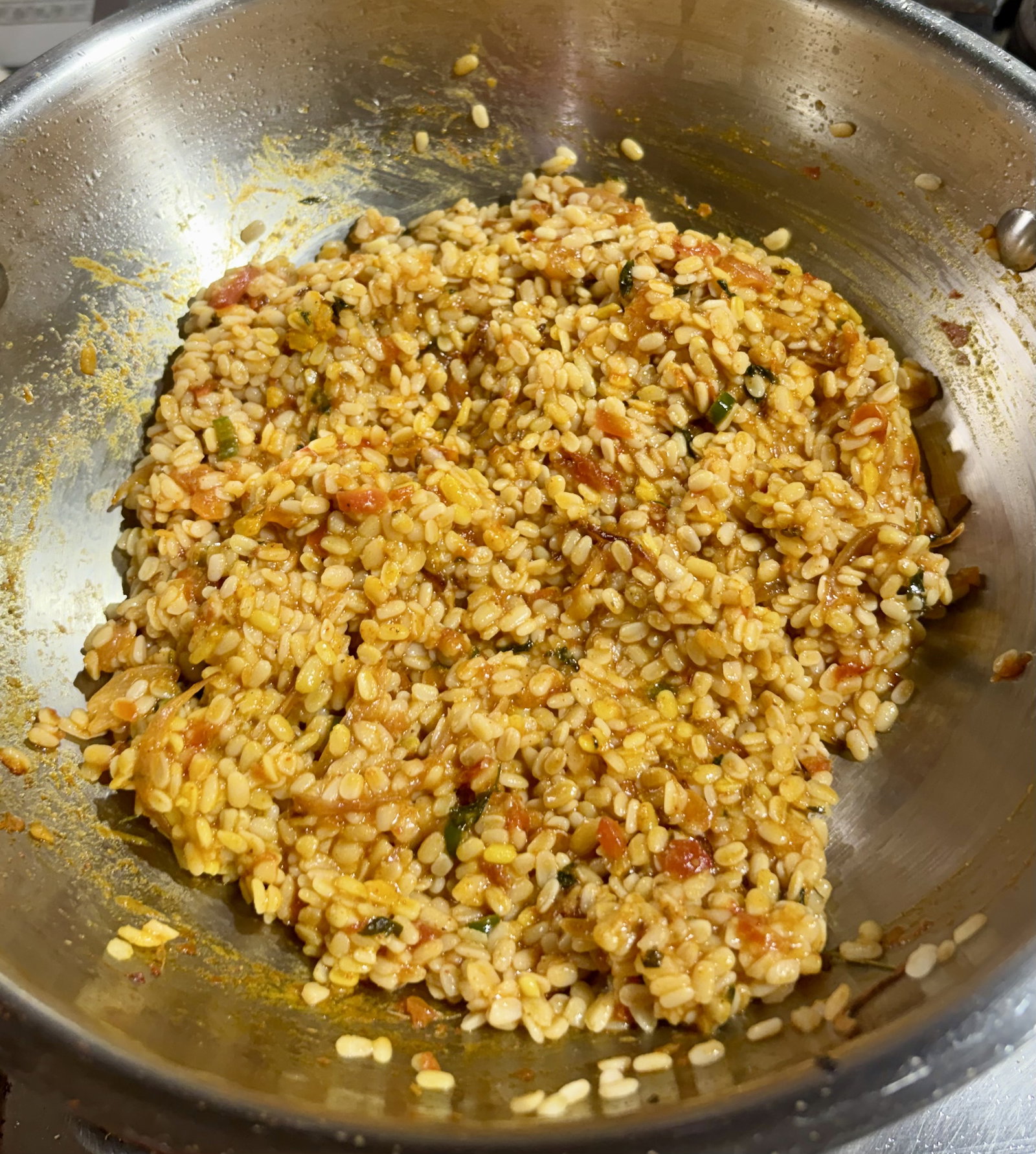 Step 3.2: Add the cooked dal into the masala pan, mixing carefully to combine without mashing the lentils