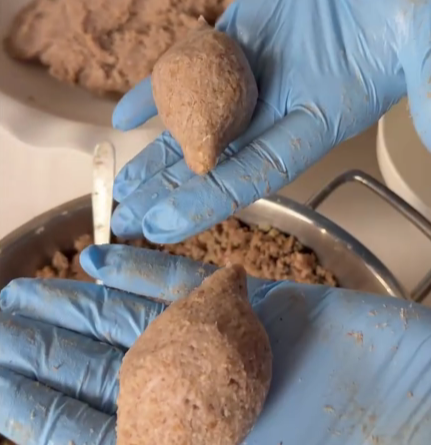 Step 3.1: Seal the opening and shape the kebbeh into an oval or torpedo shape