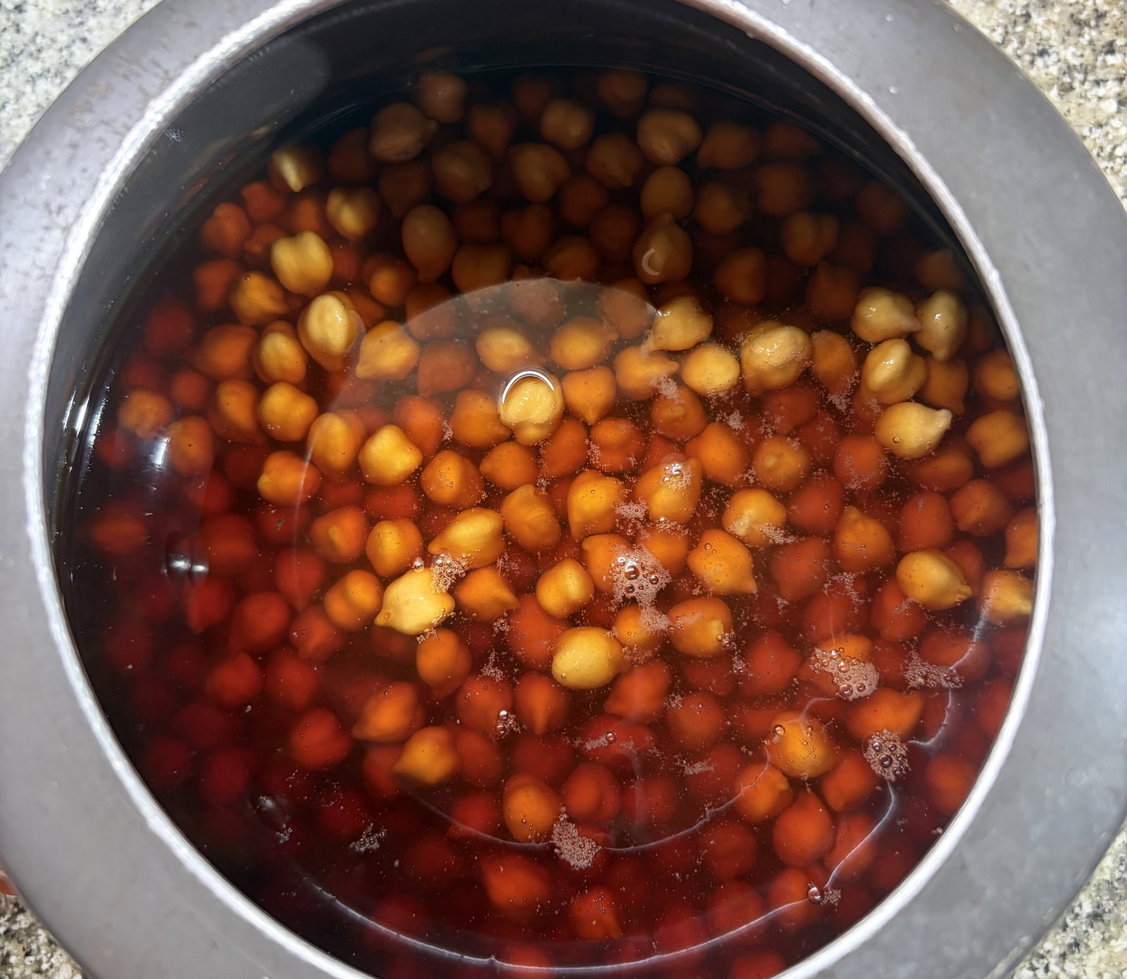 Step 1.1: In a pressure cooker, add the soaked chickpeas, brewed tea, salt, and baking soda