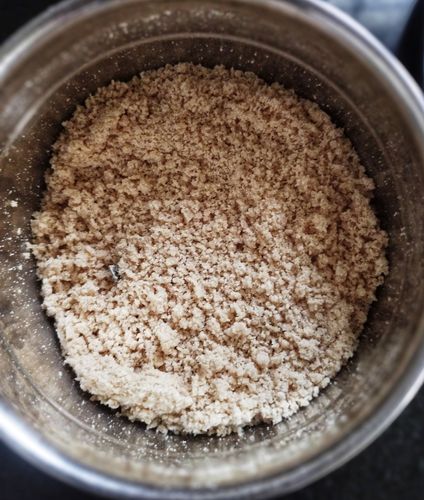 Step 1.3: Add 3-4 tbsp of the wet flour to a mixer jar or food processor, add 2 tsp of dry wheat flour, and pulse a couple of times to remove lumps and form soft puttu