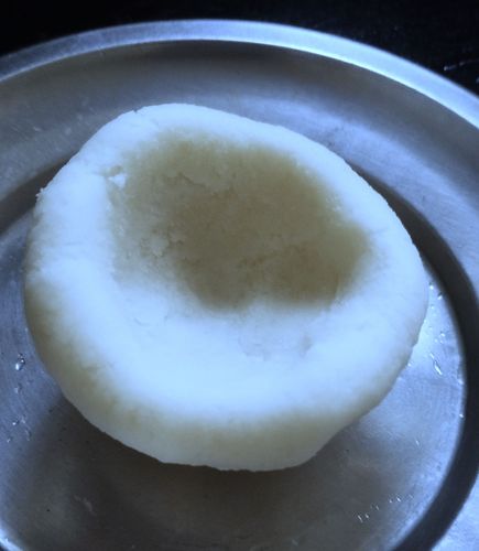 Step 2.3: Take one ball and press into the center with your thumb to make a bowl shape