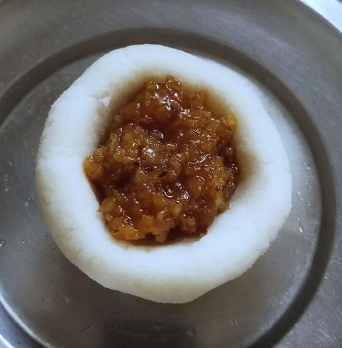 Step 2.1: Add 1 tbsp of jaggery filling to the dough bowl